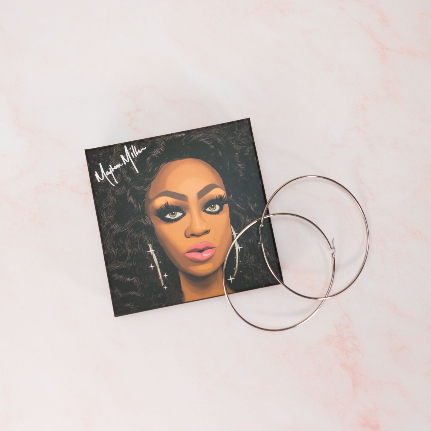 Mayhem Miller's signature hoop earrings in the Drag Society box